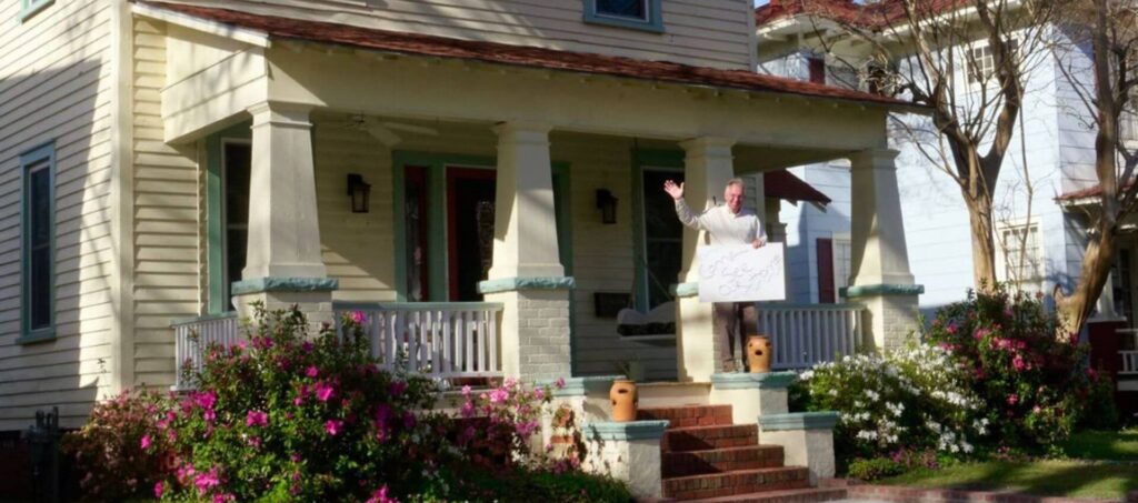 Steve Kelly waving from his front porch