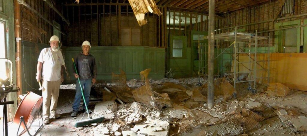 two men standing inside demolition at Union Station Depot