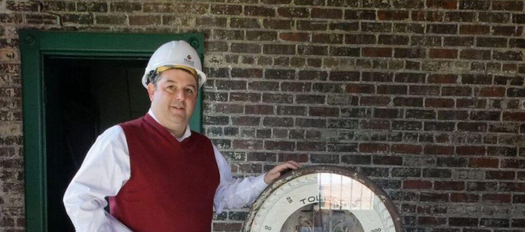 Tripp Eure next to old baggage scale