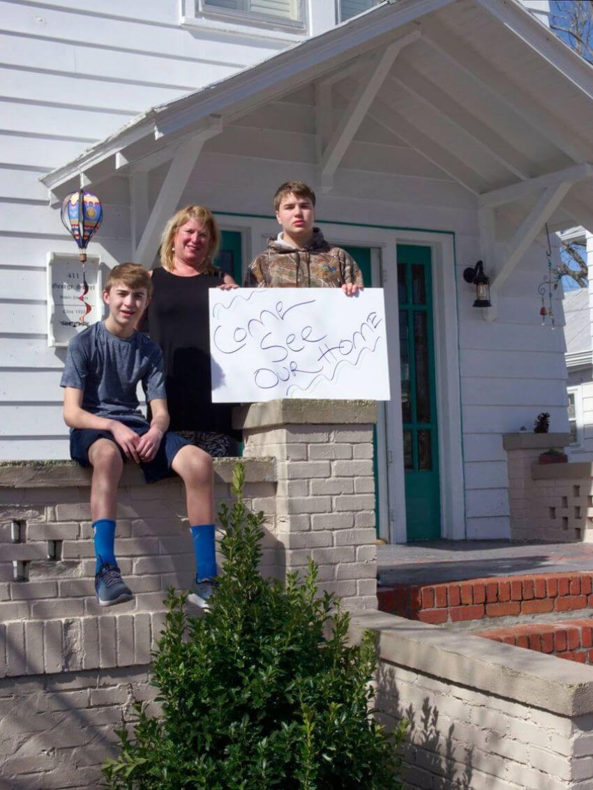 Mother and 2 sons sitting on front porch