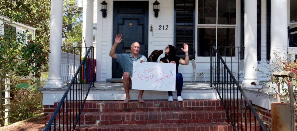 Rick Prill, Lori Ann Giovinco and their dog Miles sitting on steps