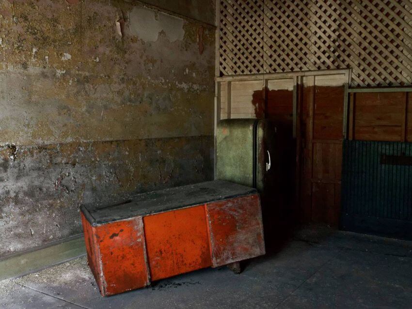 Old train station depot interior with old refrigerator and wood box