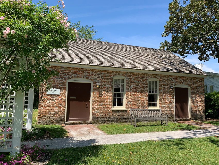 One-story old brick building with wood shingle roof