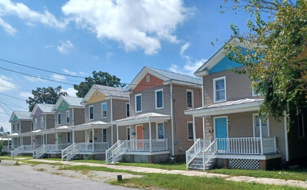 Six two-story homes with front porches and gingerbread trim